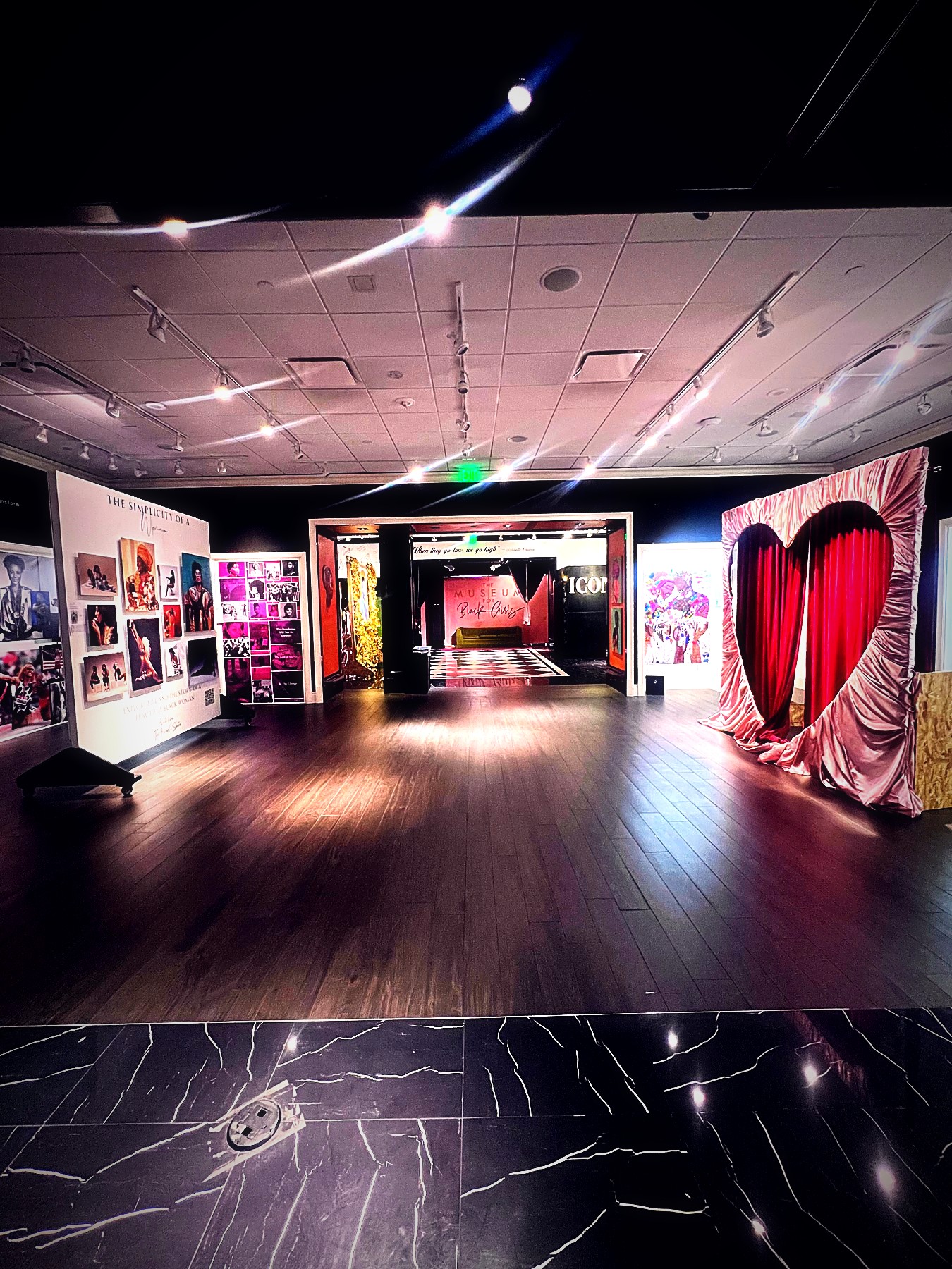 Gold-lit ICON gallery with velvet heart installation before an event at Museum for Black Girls
